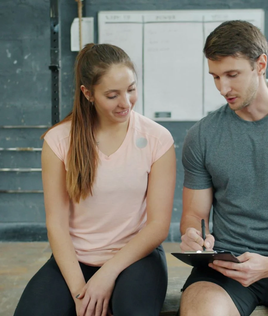 Trainer and client planning a workout