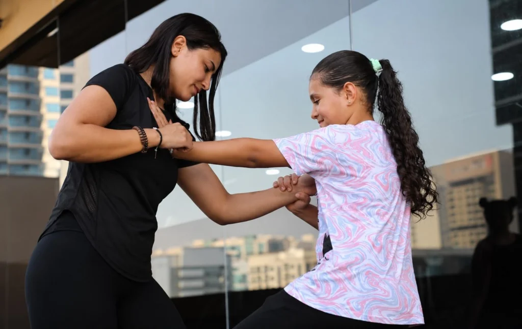 JazFit coach teaching a kids self-defense session